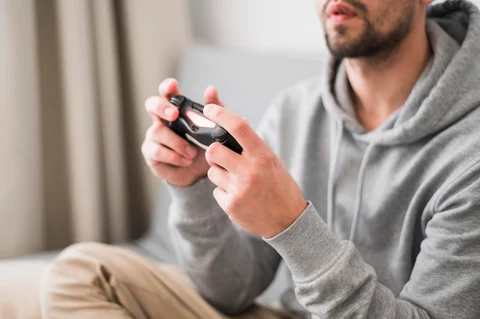 Front view man playing video games